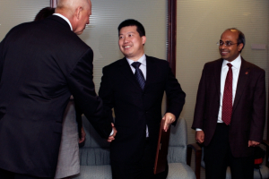Professor Yan Yao shakes Dean Tedesco's hand after receiving the Ralph E. Powe Junior Faculty Enhancement Award.